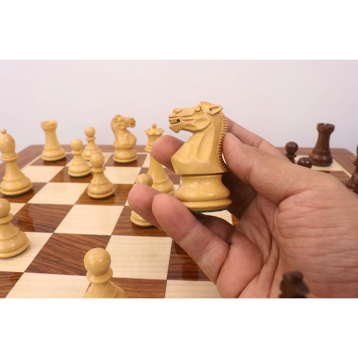 Detailed carving of a Boxwood Knight piece from the Monarch Series chess set.