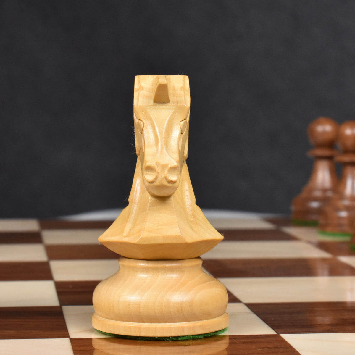 Front view of a carved boxwood Dubrovnik knight chess piece.
