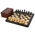 3.3" tournament Staunton ebonised boxwood chess pieces displayed on a wooden board next to a storage box.