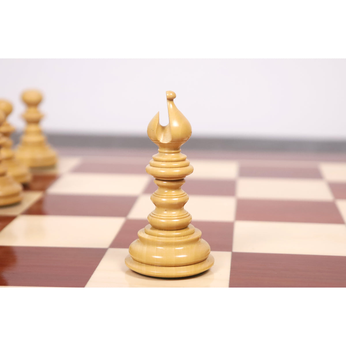 Close-up of a hand-carved white bishop piece from the Marengo luxury Staunton chess set.