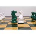 Green and white Staunton weighted knight chess pieces.