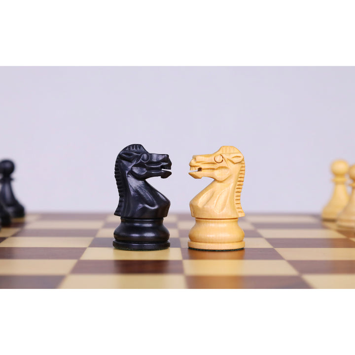Close-up of ebonised boxwood and boxwood knight chess pieces on a magnetic travel chess board.