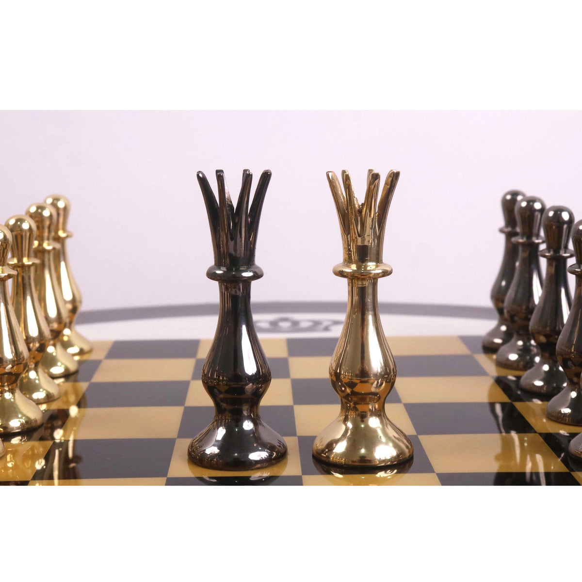 Regal Curve Series metallic grey and gold brass queens facing each other.