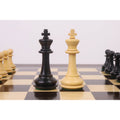 The light and dark wood King pieces from the 3.9" Heritage Series Staunton chess set are positioned centrally on a chessboard.
