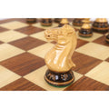 A close-up side view showcasing the detailed carving of a golden rosewood Staunton knight on a 20-inch legacy board.