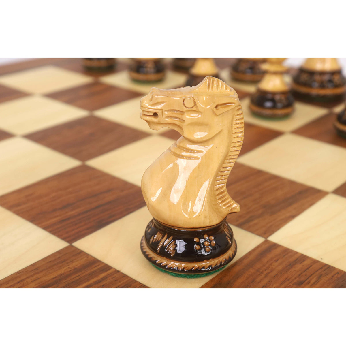 A close-up side view showcasing the detailed carving of a golden rosewood Staunton knight on a 20-inch legacy board.