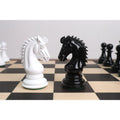 Black and white 4.1-inch texture painted Staunton boxwood chess knights facing each other in a close-up.