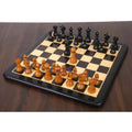 Full setup of the antiqued and ebonised English Dublin chess pieces on a wooden board with a light pawn advanced.