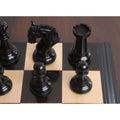 Jet-black ebony wood pawns, knight, and rook on a luxury wood chessboard corner.