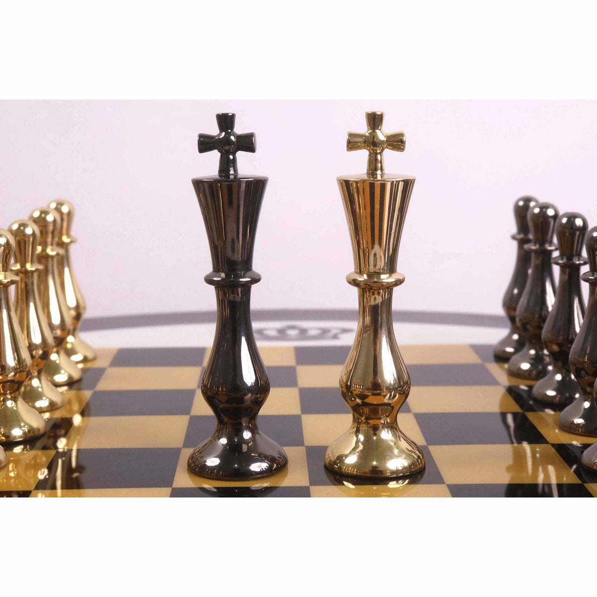 Metallic grey and gold brass kings of the Regal Curve Series chess set.