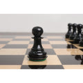 Detailed view of a glossy black Pro Staunton wooden pawn piece on a handcrafted ebony board.