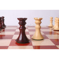 Dark Bud Rosewood and light Boxwood rooks on a luxury chessboard.