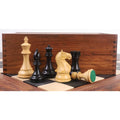 Weighted boxwood and ebonised chess pieces arranged with a premium wooden storage box.