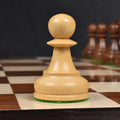 Close-up of a single boxwood Dubrovnik pawn chess piece on a wooden board.