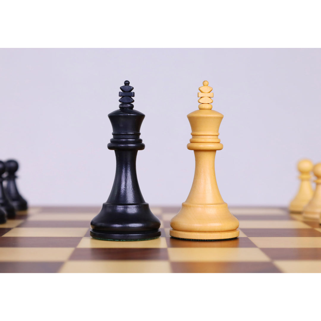 Ebonised boxwood and boxwood king chess pieces displayed on a magnetic travel chess set.