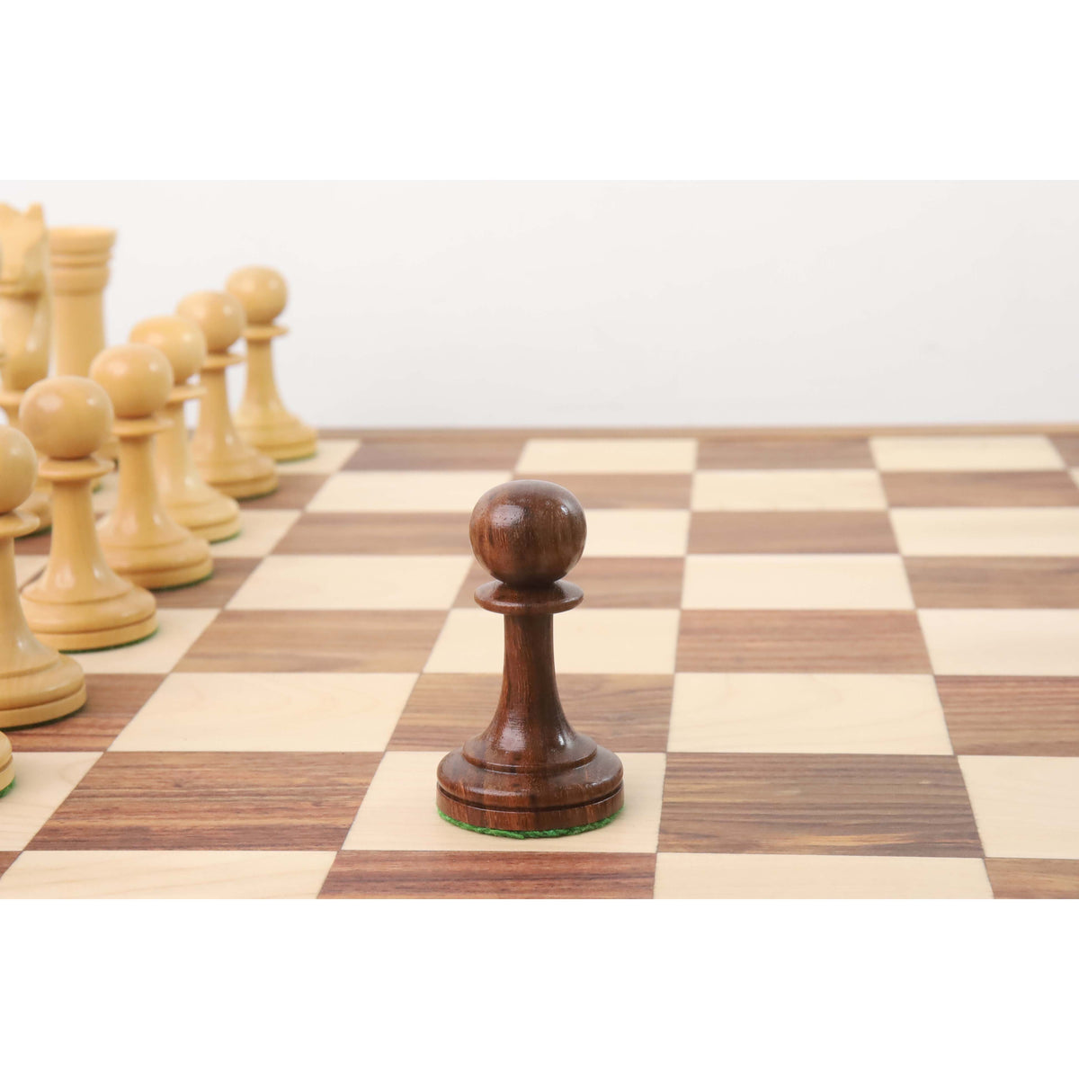 Dark golden rosewood pawn piece centered on a 21-inch Drueke style board square.