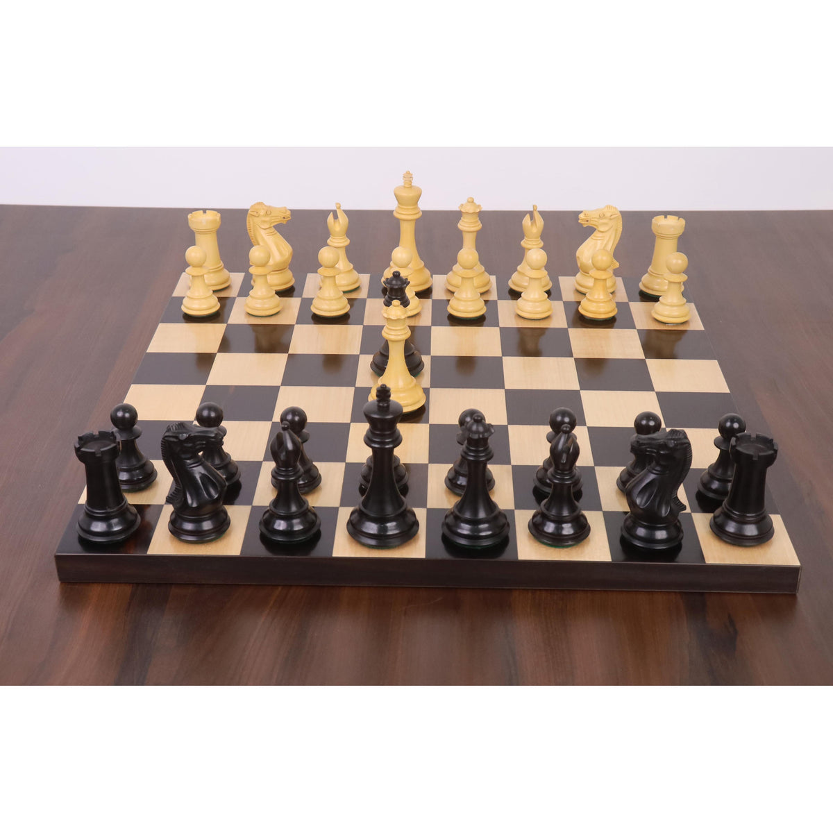 Complete 4" Sleek Staunton luxury chess set in ebony and boxwood, fully set up for play on a glossy board.