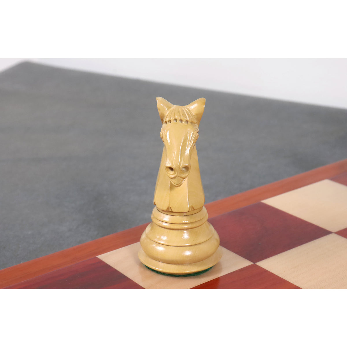 Front perspective of a meticulously detailed, hand-carved natural boxwood knight piece.