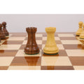 Weighted Golden Rosewood and Boxwood Rook pieces displayed on a Monarch Series chess table.