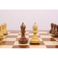 Close-up of the Golden Rosewood Rook and Pawn pieces on a tournament-sized wooden chess board.