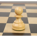 Natural boxwood pawn from the Reykjavik series positioned on a wooden chessboard square.