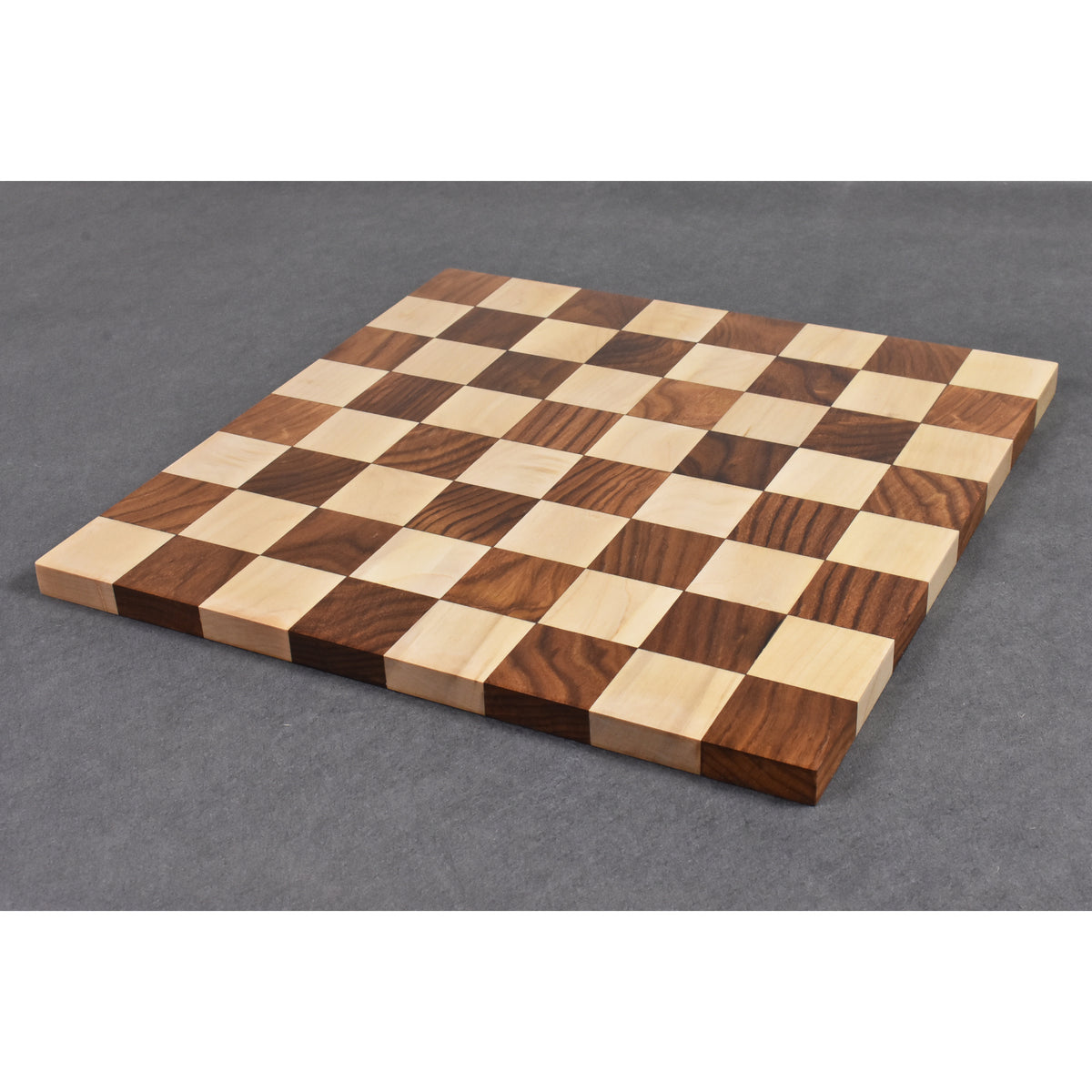 A full view of the borderless Golden Rosewood and Maple chessboard on a grey background.