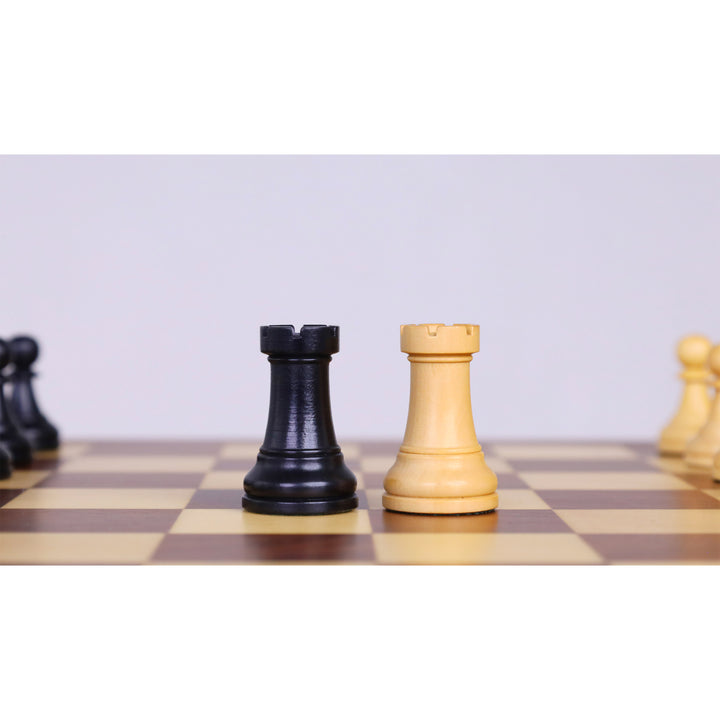 Ebonised boxwood and boxwood rook chess pieces displayed on a magnetic travel chess set.