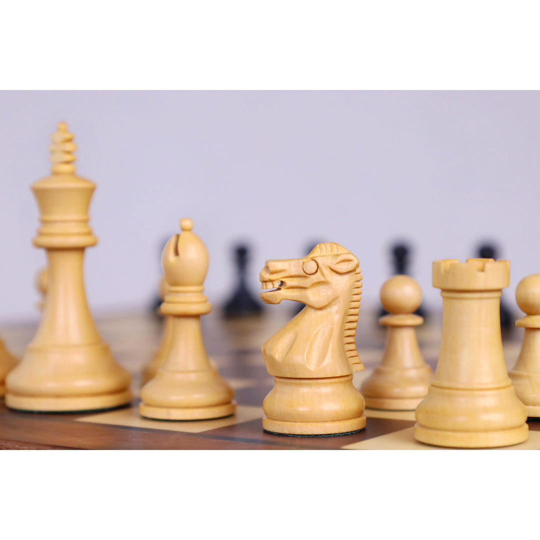 Boxwood Staunton chess pieces lined up on a magnetic travel chess board.