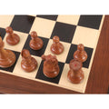 Overhead view of antiqued boxwood 1849 Cooke Staunton chess pieces on a chessboard.