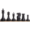 Complete set of ebony wood 1849 Cooke Staunton chess pieces including king, queen, and minor pieces.