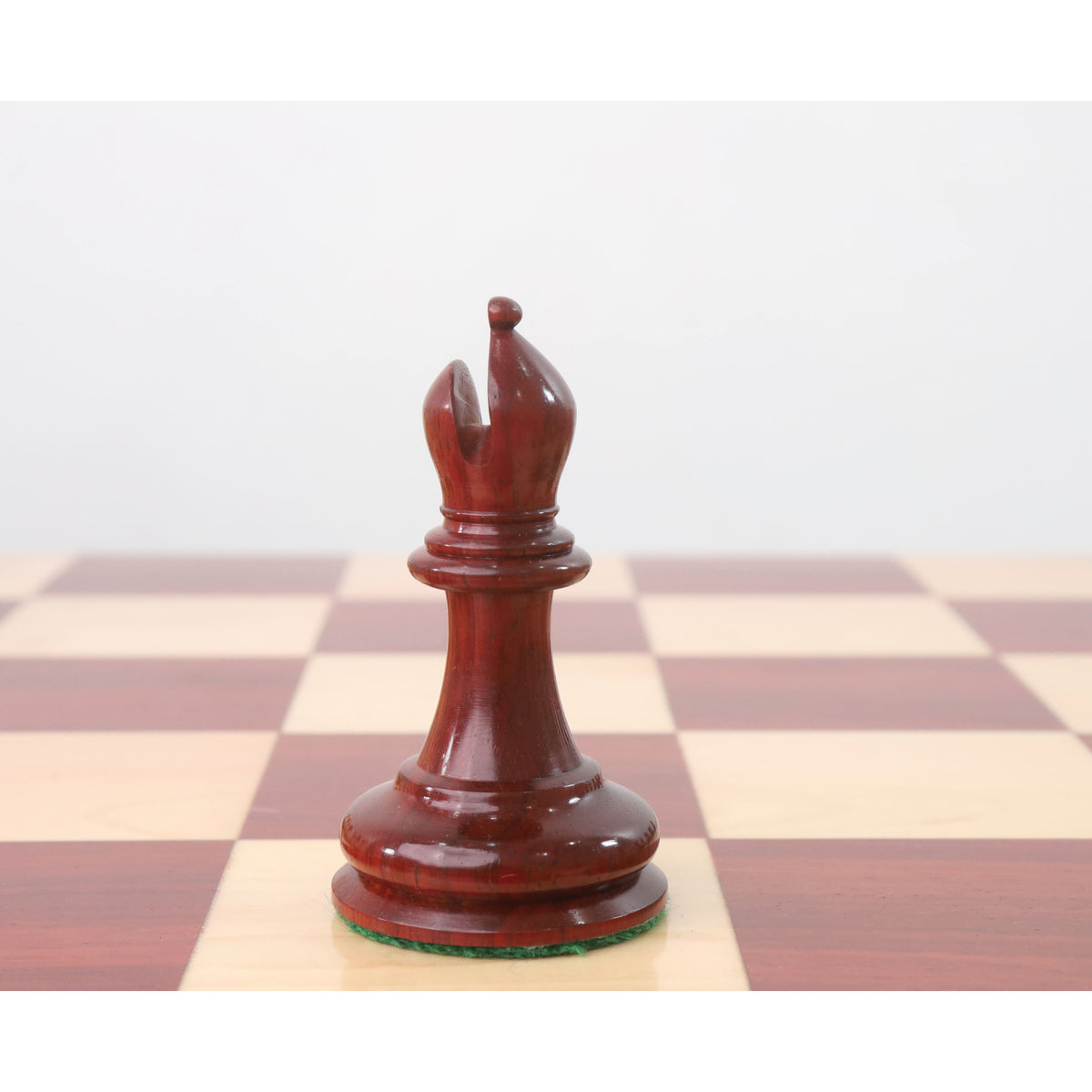 Polished Bud Rosewood Bishop from the 1849 Jacques Cook Staunton collectors set on a board.