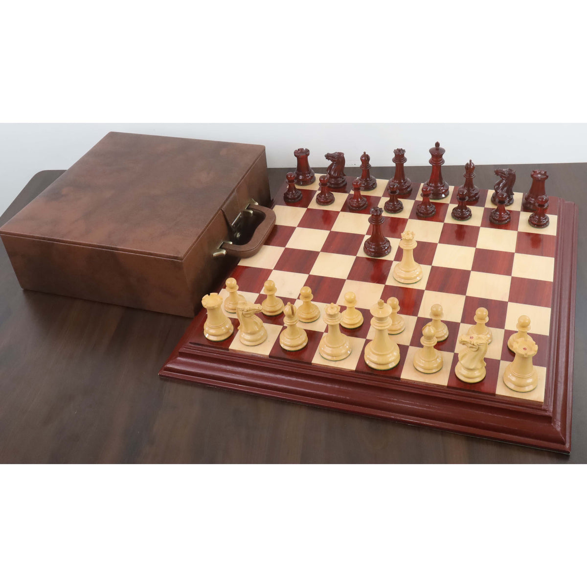 1849 Jacques Cook Staunton chess set displayed on a board with a luxury brown leatherette case.