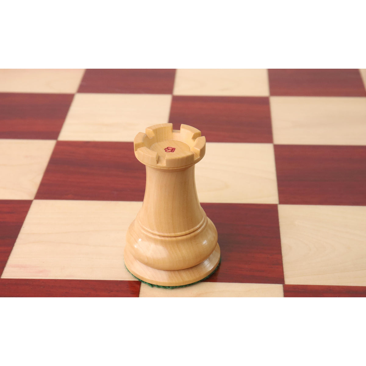 Close-up of a boxwood rook from the 1849 Jacques Cook Staunton set featuring a red king's side stamp.