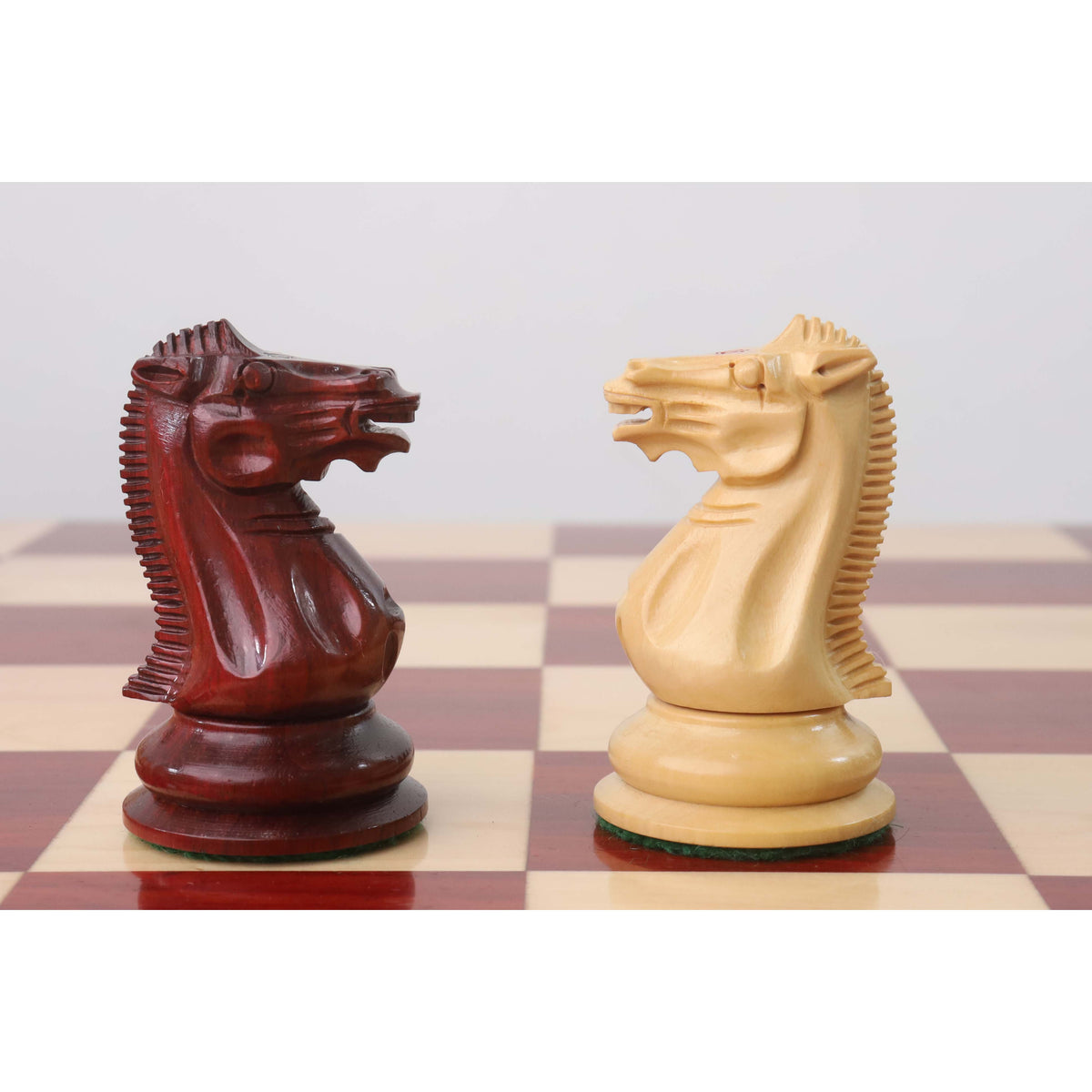 Opposing hand-carved Knights in Bud Rosewood and Boxwood from the 1849 Jacques Cook Staunton set.