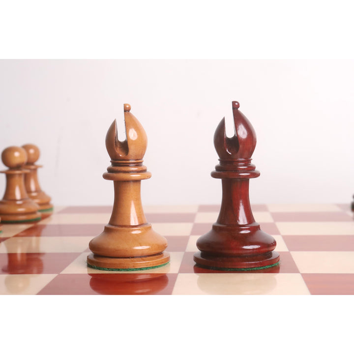 Antiqued boxwood and bud rosewood bishops from the 1849 Staunton chess set on a board.