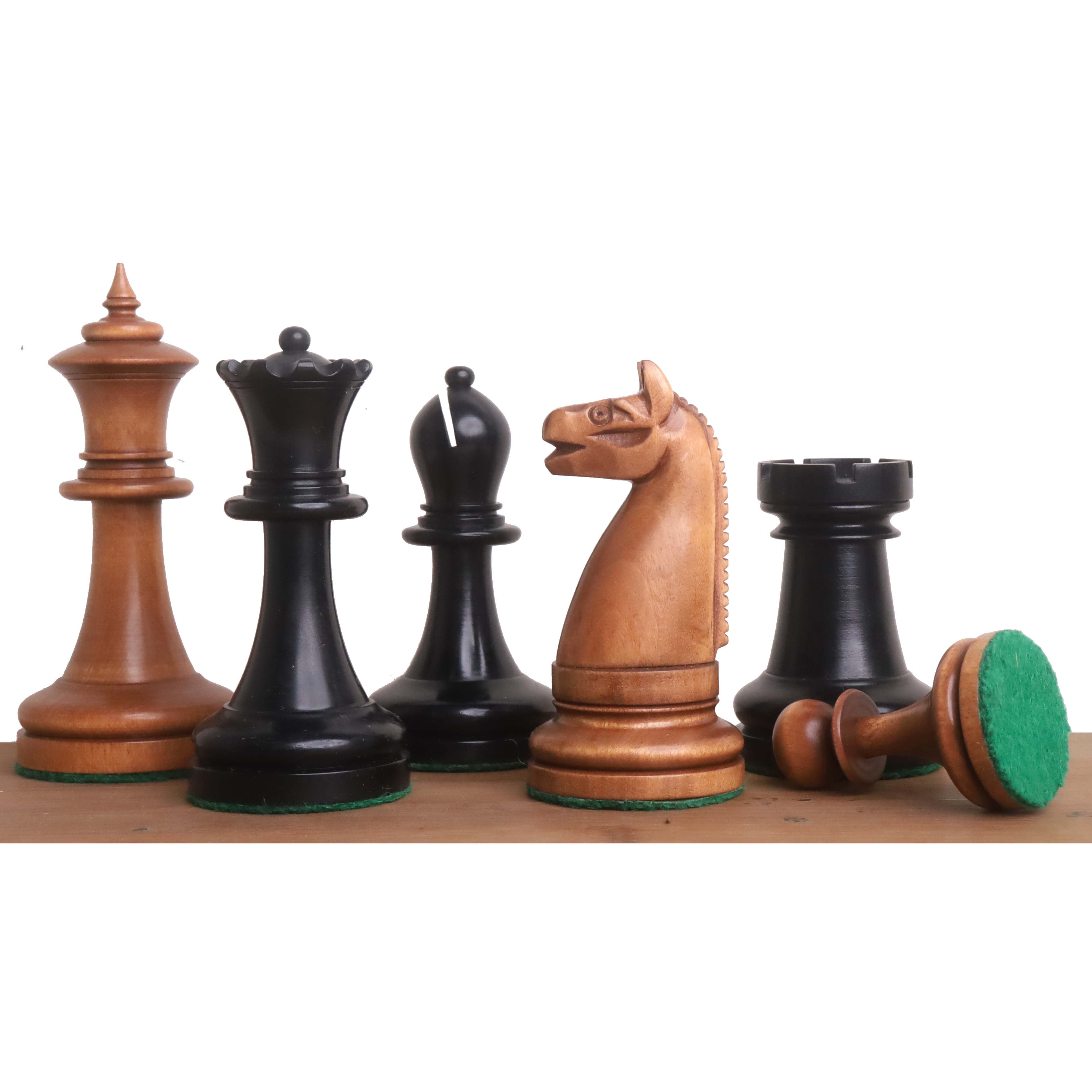 Antiqued and ebonized boxwood chess pieces with green felt bases in a decorative row.