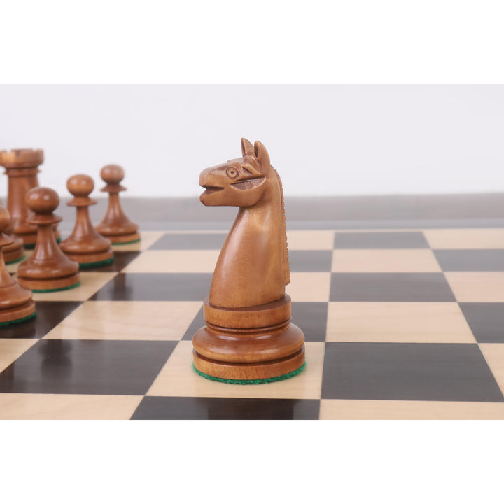 Profile of a 1900s American reproduction Knight in antiqued boxwood on a chess board.