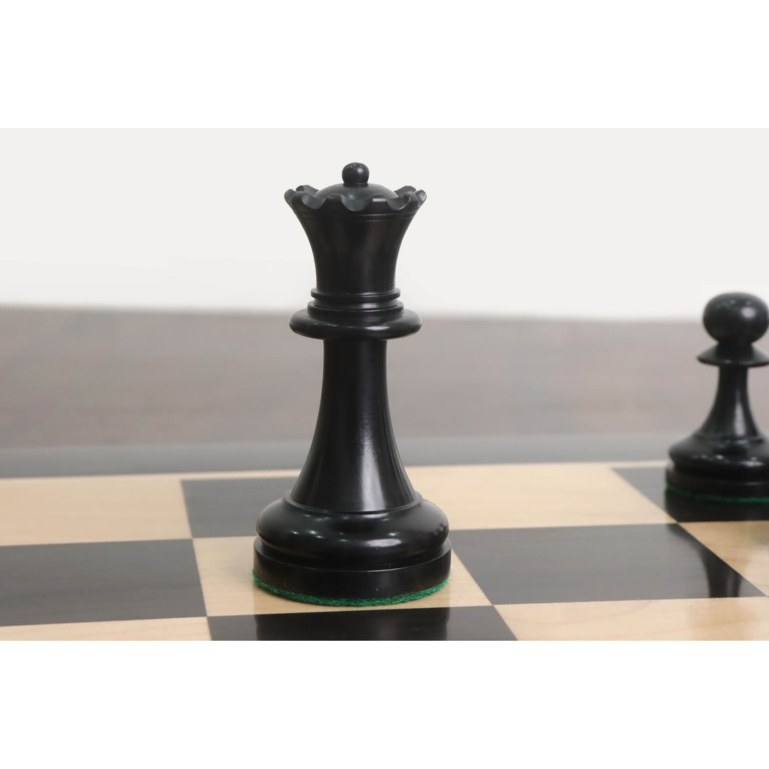 Ebonised boxwood queen from the 1900s American Chess Company reproduction set on a wooden board.