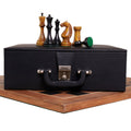 1935 Botvinnik Flohr II Soviet chess set pieces displayed on a black leather storage box.