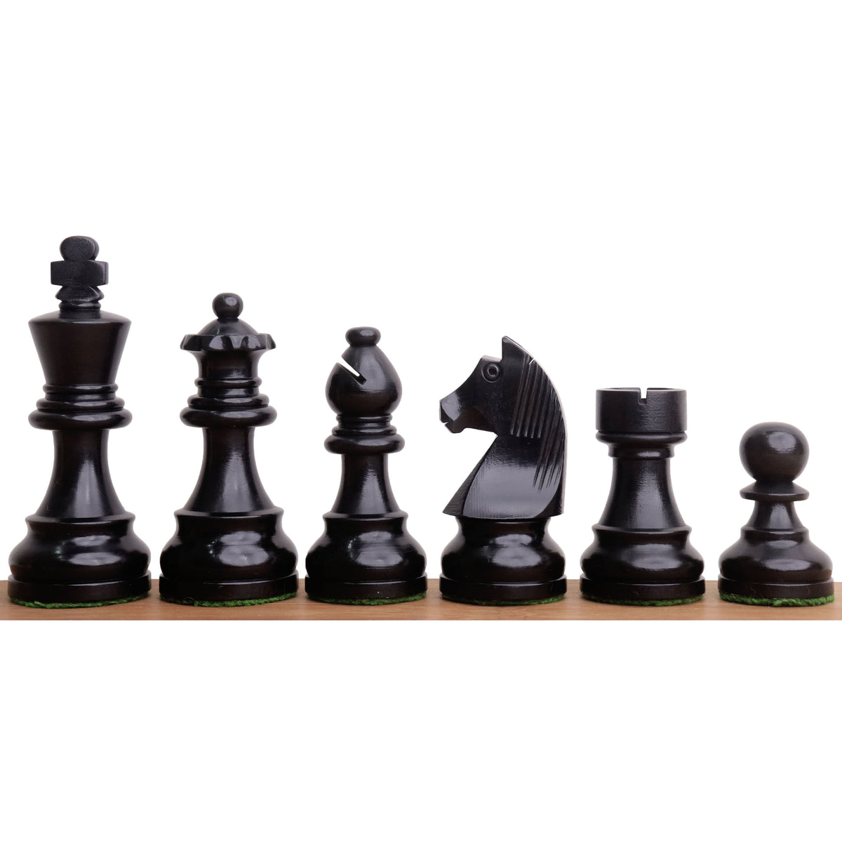 Black ebonised boxwood Tournament Staunton chess pieces lined up in a row from king to pawn.