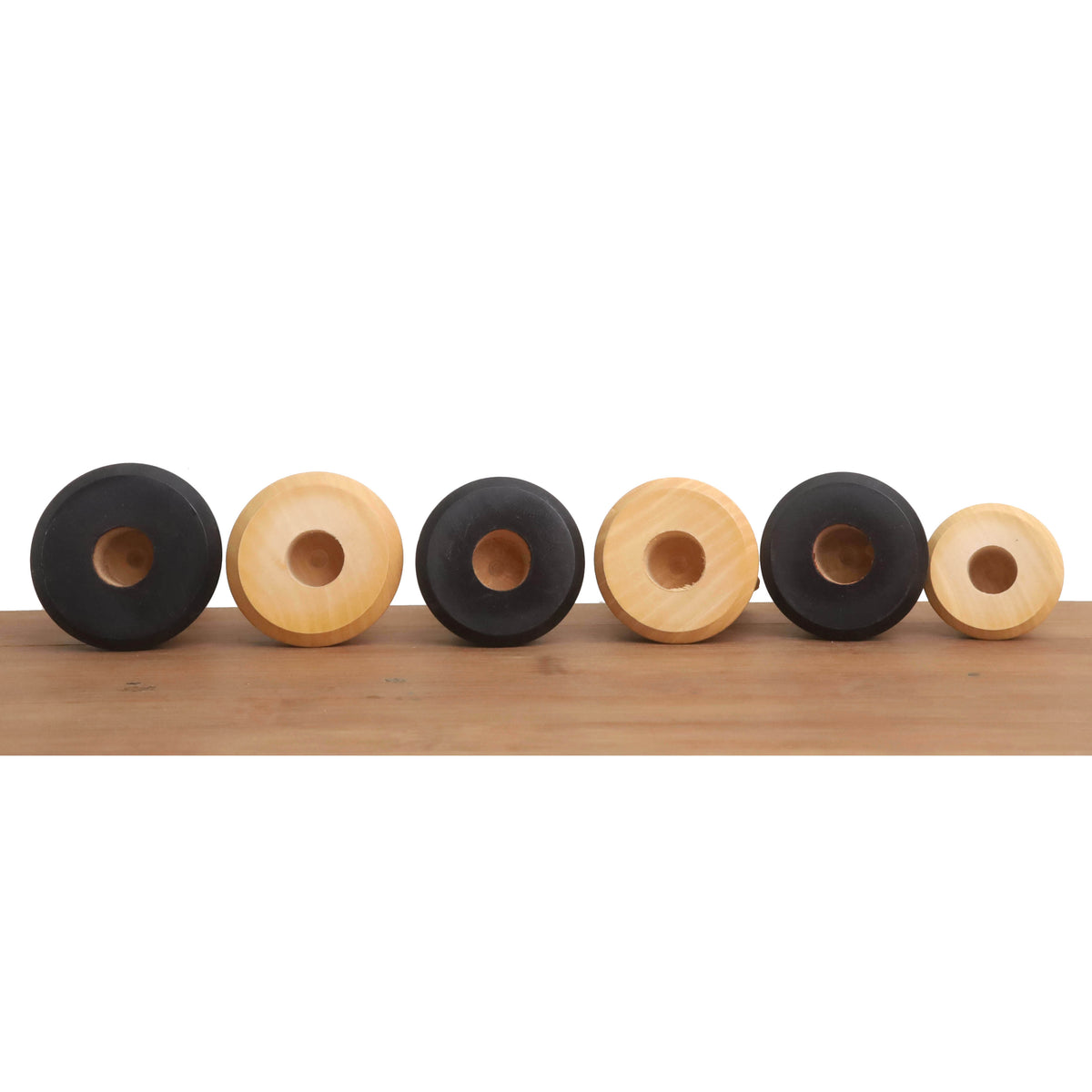 Bottom view of ebonised Staunton chess pieces with sensor-compatible recessed bases.