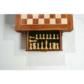 Top-down view of the built-in storage drawer with green felt lining, neatly holding the Boxwood Pro Staunton chess pieces.