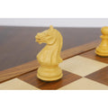 Detailed view of a handcrafted boxwood knight chess piece on a wooden board.