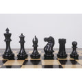 Close-up profile of Ebonised Pro Staunton pieces lined up on a wooden chessboard.