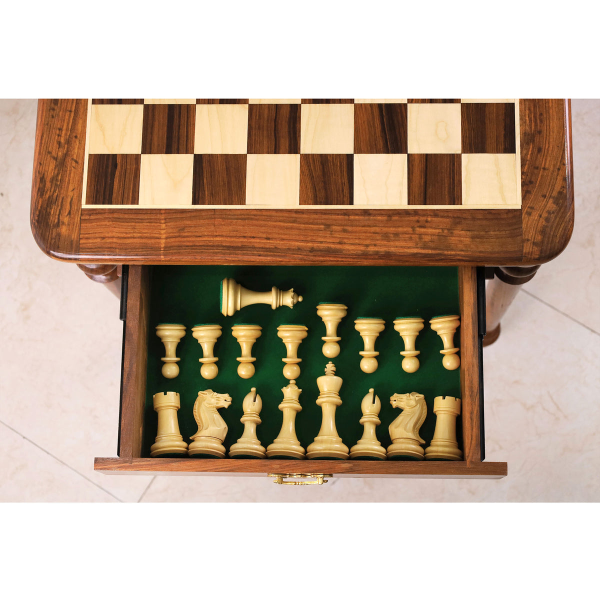 Interior of chess table storage drawer showing organized weighted staunton pieces.