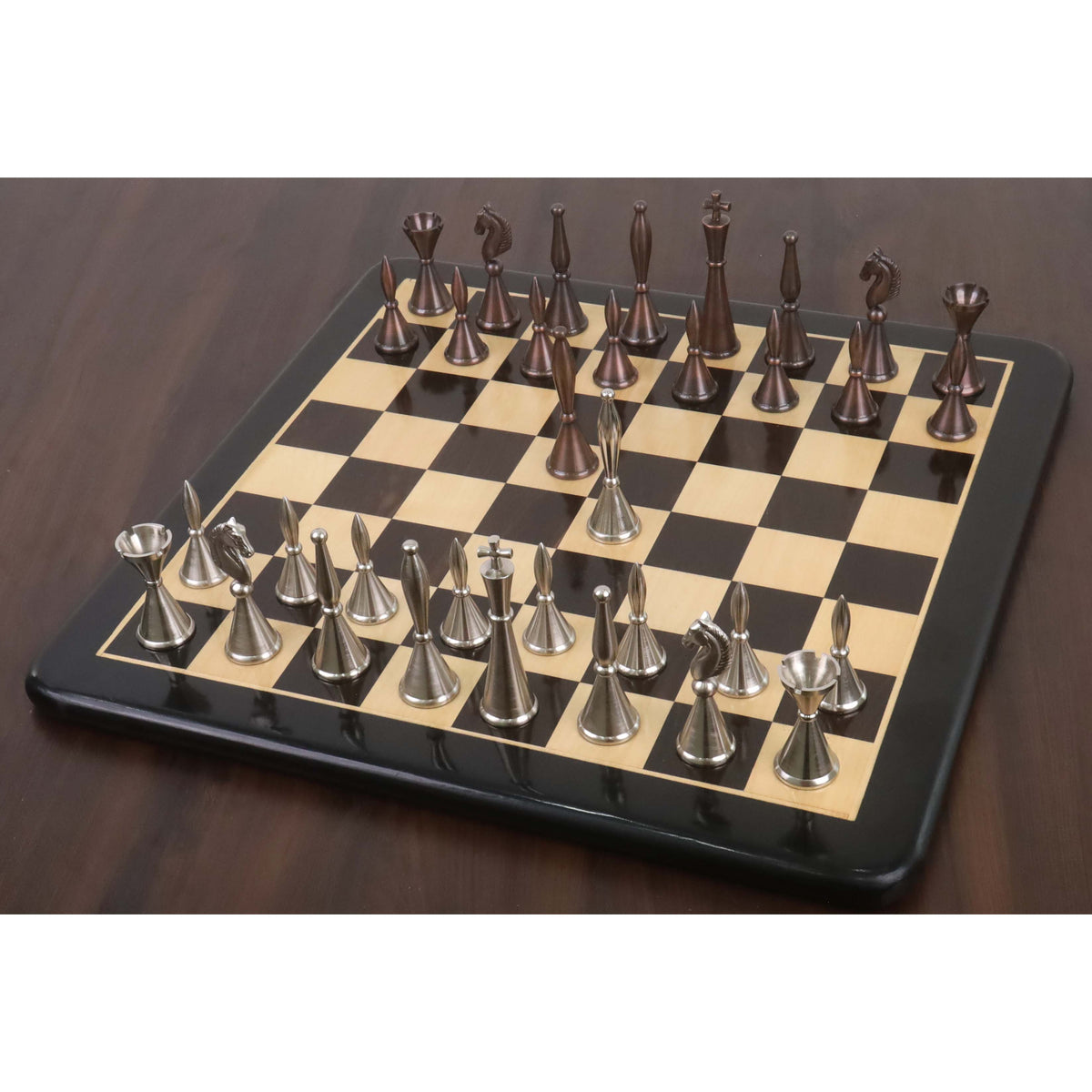 Full set of luxury metal chess pieces on a premium wooden chess board.
