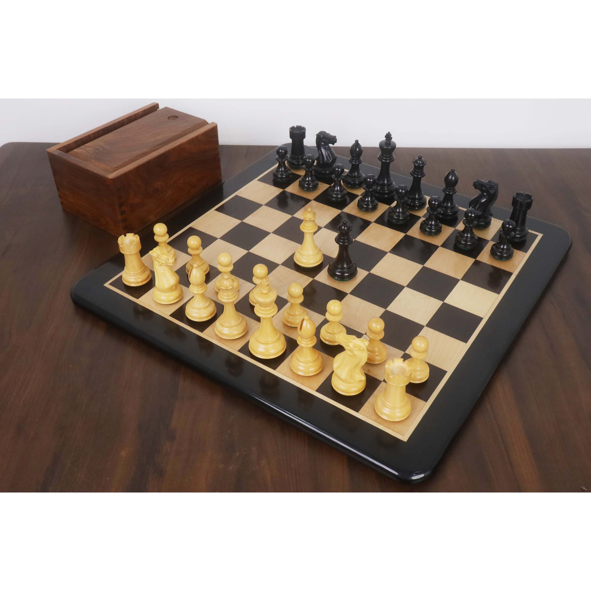 Ebonised Pro Staunton chess set fully set up on a 21-inch board with storage box.