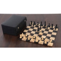 Full wooden chess set on a dark board with a premium black leather storage case nearby.