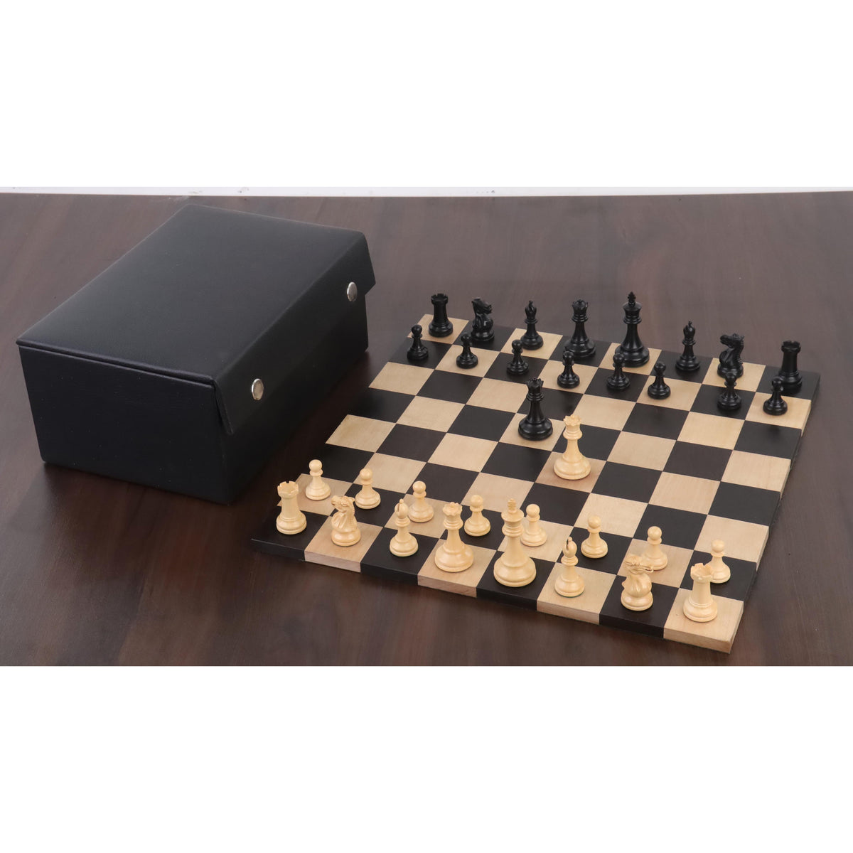 Full wooden chess set on a dark board with a premium black leather storage case nearby.