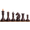 Lineup of dark rosewood Candidates Series minimalist chess pieces, from king to pawn, against a white background.